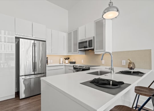 a kitchen with white cabinetry and stainless steel appliances