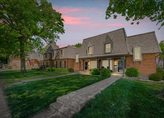 A house with a brick facade and a large front yard.