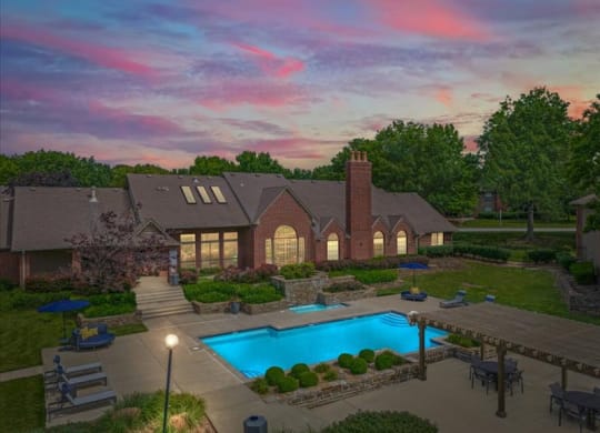a backyard with a swimming pool and a house at Highland Park Apartment Homes, Overland Park