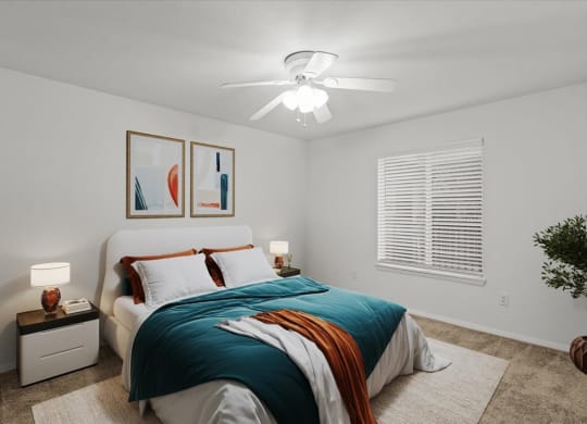 a bedroom with a bed and a ceiling fanat Millcreek Woods Apartments, Olathe, 66061