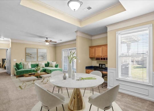 A dining area with a large window, crown molding and a built-in desk