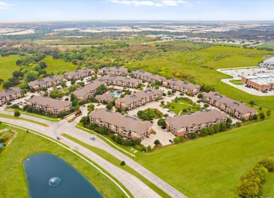 an aerial view of a subdivision with a lake in the foreground