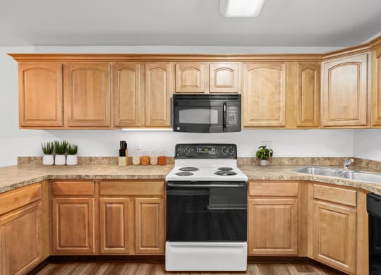 a kitchen with wooden cabinets and a black and white stove top oven