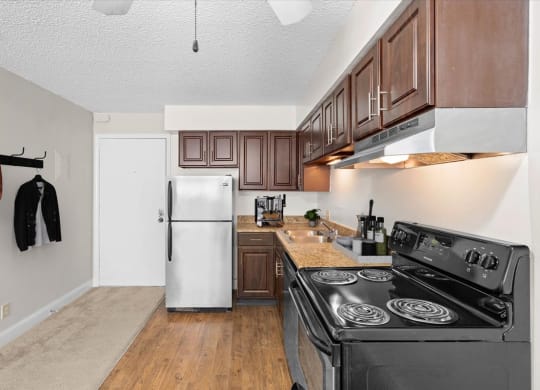 a kitchen with stainless steel appliances and wooden cabinets