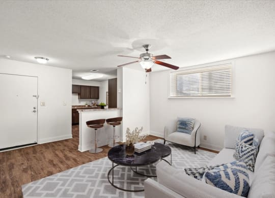 a living room with a couch and a ceiling fan at Fiesta Square Apartments & Townhomes, Kansas, 66212