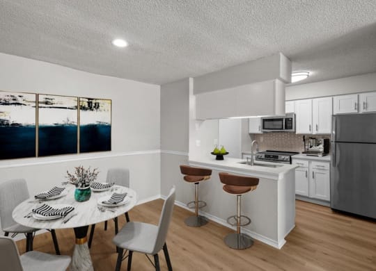 a kitchen and dining room with a table and chairs at Highland Park Apartment Homes, Overland Park