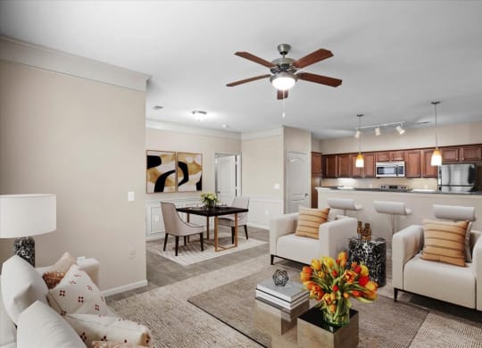 A living room with a dining area, open kitchen, crown molding and ceiling fan.