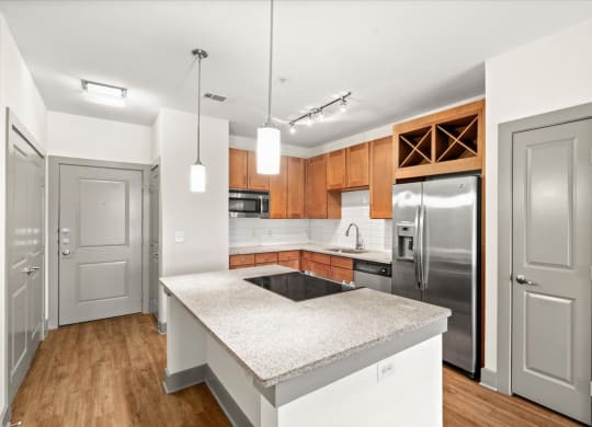 a kitchen with an island and stainless steel appliances