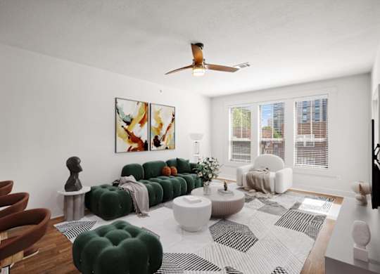 A living room with a ceiling fan, lots of windows for natural lighting, and hardwood floors.