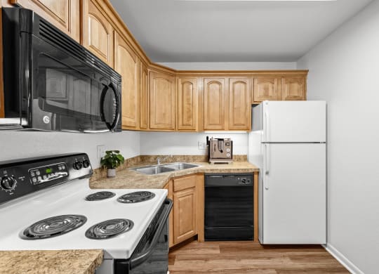a kitchen with wooden cabinets and white appliances