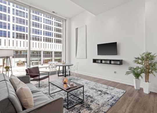 a living room with a large window and a couch