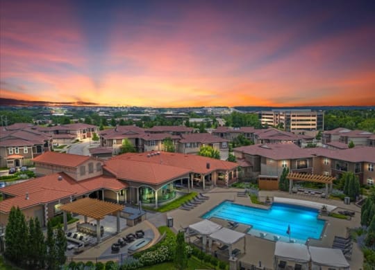 an aerial view of a resort with a swimming pool
