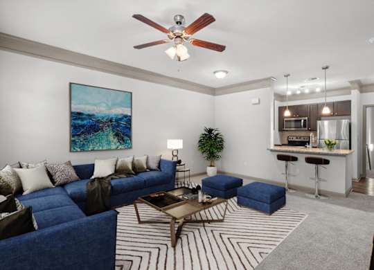 a living room with a blue couch and a coffee table at Stonepost Crossing Apartments, Kansas, 66213
