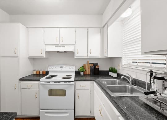 a kitchen with white appliances and white cabinets