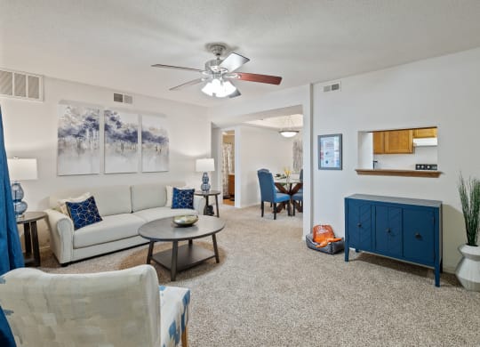 a living room with a white couch and a blue cabinet at Waterford Place Apartments & Townhomes, Kansas, 66210