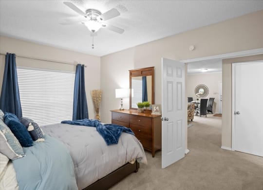 a bedroom with a bed and a ceiling fan at Creekview Apartment Homes, Texas