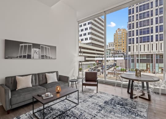 a living room with a large window and a view of a city