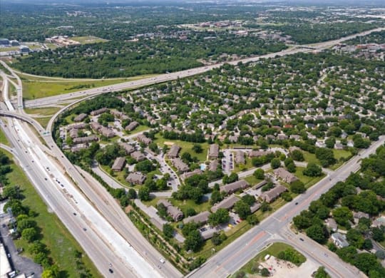 an aerial view of a city with highways and houses at Highland Park Apartment Homes, Kansas, 66214