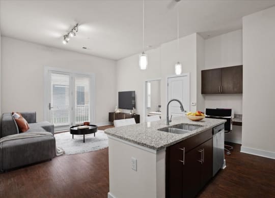 a kitchen with an island and a living room with a couch