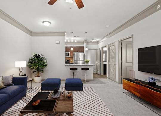 a living room with couches and a coffee table at Stonepost Crossing Apartments, Overland Park