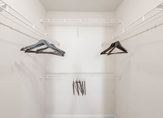 a spacious walk in closet with white walls and a white ceilingat Stonebriar Woods Apartments, Overland Park
