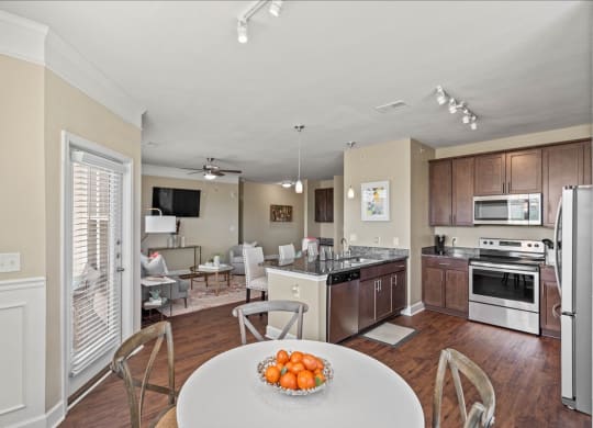 a kitchen and living room with a table and chairs at The Residences at Bluhawk Apartments, Kansas, 66085