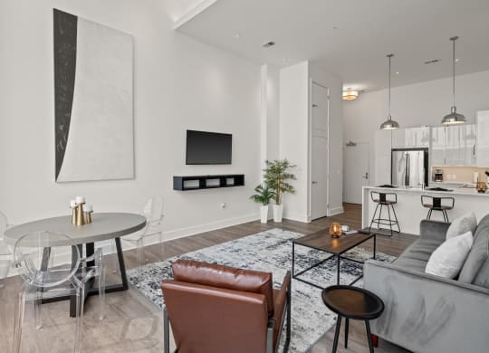a living room with white walls and hardwood floors