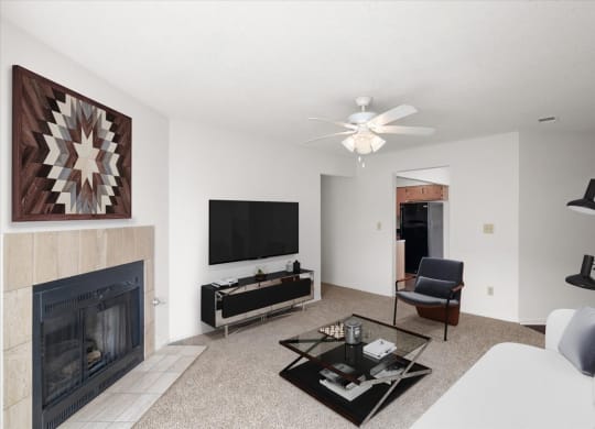 a living room with a fireplace and a tv at Deerfield Apartments, Olathe, KS