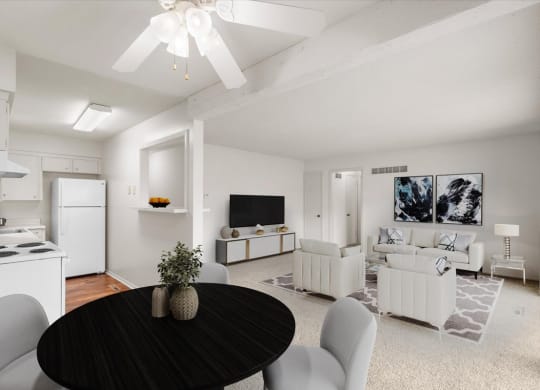 A large open layout with a ceiling fan, dining room, living area, and kitchen at a pet friendly apartment community.