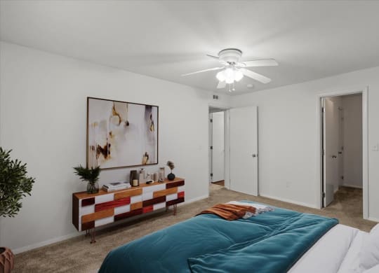 a bedroom with a bed and a ceiling fanat Millcreek Woods Apartments, Olathe, Kansas