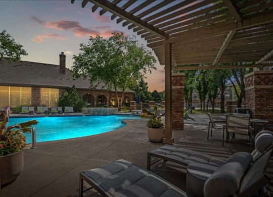 An outdoor swimming pool with a loggia lounge chair seating.