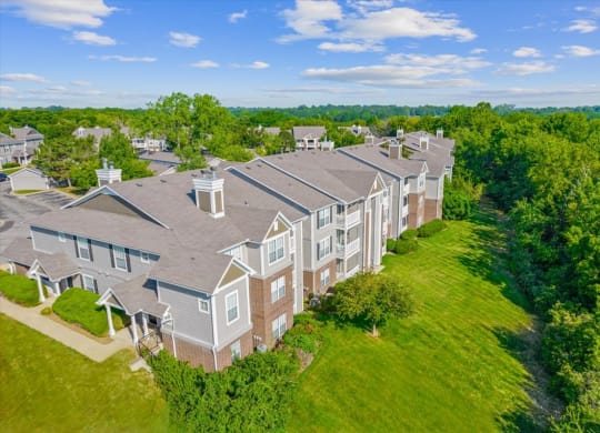 an aerial view of a row of houseat Stonebriar Woods Apartments, Overland Park, KSs in a grassy area