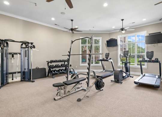 A spacious home gym with a variety of exercise equipment. at Stonepost Lakeside Apartment Homes, Olathe, 66062