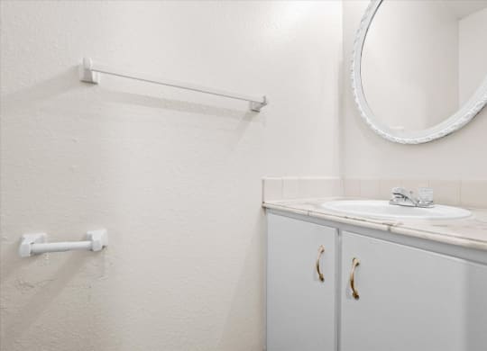 a white bathroom with a sink and a mirror