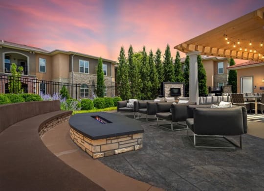 a large patio with chairs and a fire pit