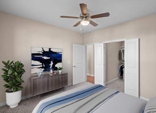 a bedroom with a large bed and a ceiling fan at The Dorset, Kansas City, 64112