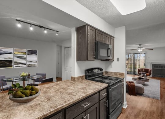 a kitchen and living room with a granite counter top