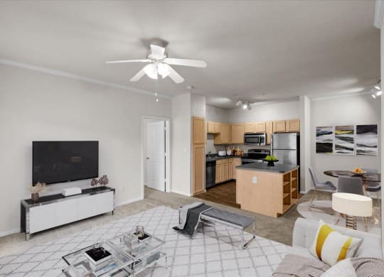 a living room with a ceiling fan and a kitchen at Stonepost Lakeside, Olathe, 66062