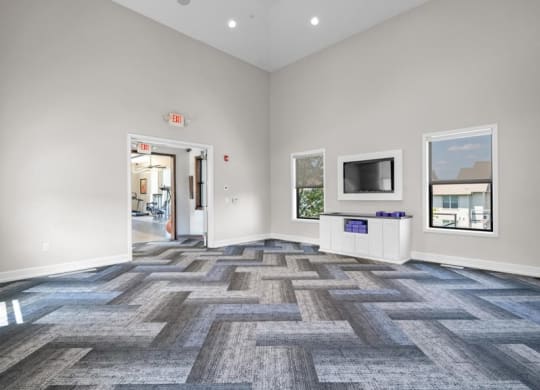 a living room with a tv and a door to a hallway