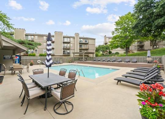Pool area with table and chair at Cloverset Active Adult Apartments, Kansas City