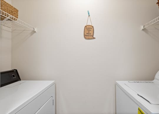 a washer and dryer in a laundry roomat Stonebriar Woods Apartments, Kansas