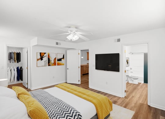 a bedroom with a bed and a ceiling fan