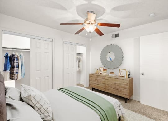 a bedroom with a ceiling fan and a closet at Fiesta Square Apartments & Townhomes, Kansas, 66212