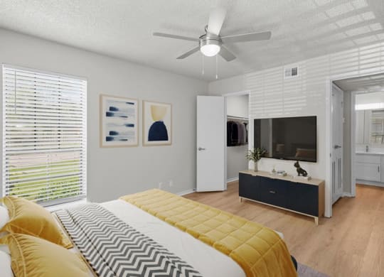 a bedroom with a bed and a tv at Highland Park Apartment Homes, Overland Park