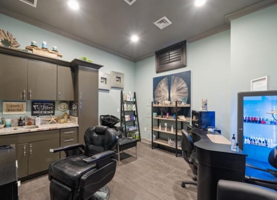 a salon room with two chairs and a computer