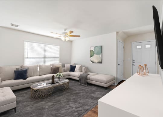 a living room with a large couch and a coffee tableat Stonebriar Woods Apartments, Overland Park