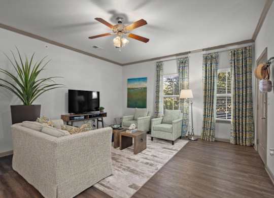 a living room with a ceiling fan and couches at Stonepost Crossing Apartments, Overland Park, KS