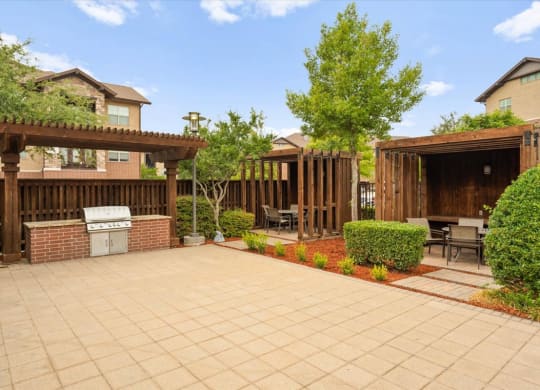 a patio with a grill and a barbecue