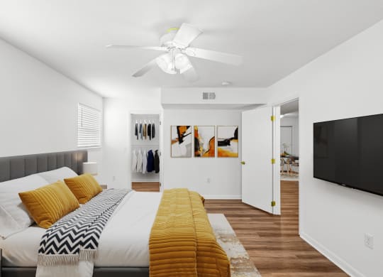a bedroom with a large bed and a ceiling fan