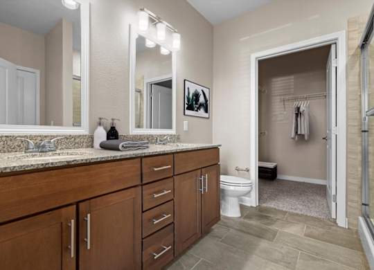 a bathroom with a large vanity and a walk in shower at The Dorset, Kansas City, Missouri